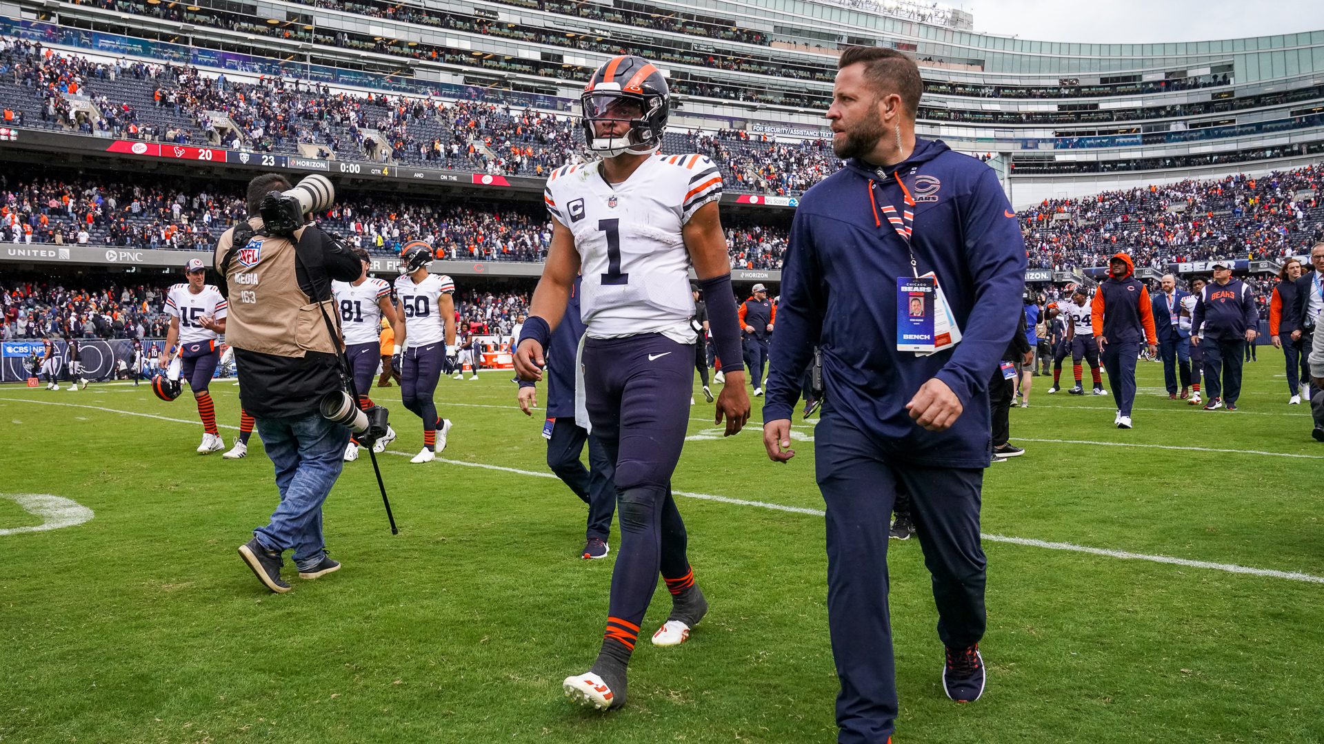 A Chicago Bears fan holds a quarterback Justin Fields jersey