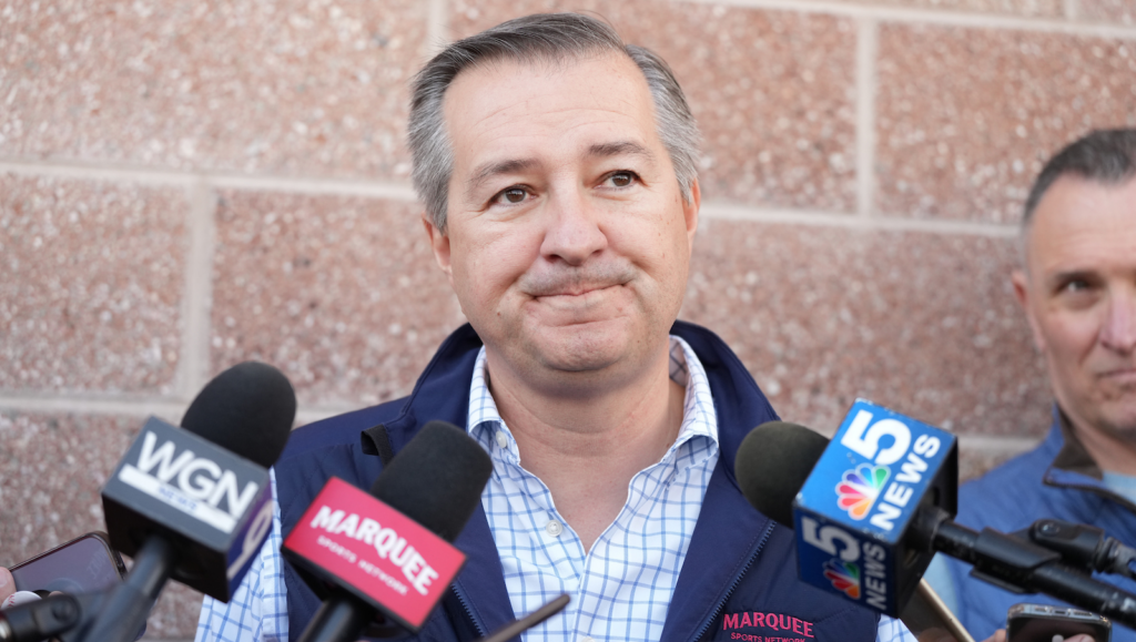 Tom Ricketts Addressing Media With Marquee Vest On