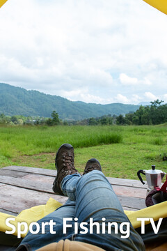 Man,legs,in,blue,jeans,and,hiking,shoe,lying,down